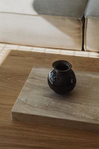 Kaboompics - Black ceramic vase on travertine coffee table - minimalist living room