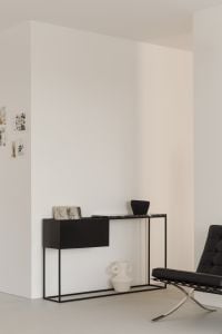 Kaboompics - Minimalist Black Console with Lounge Chair and Sheer Curtains