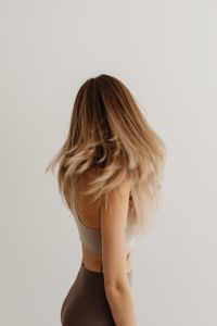 Kaboompics - Back View of Woman Standing Against a Neutral Wall