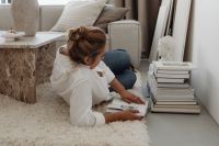 Kaboompics - Woman Reading on the Floor Beside Books and a Sleeping Dog