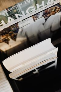 Kaboompics - Open White Book with Design Magazines in a Minimalist Interior