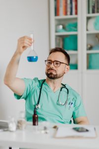 Kaboompics - Doctor Listening to Flask With Stethoscope