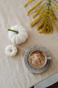 Autumn Still Life on Beige Linen: White Pumpkins, Coffee, Goldenrod, Fruit and Orange Roses