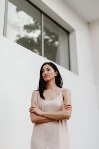 Kaboompics - Neutral Fashion Portrait of Woman in Pale Dress Looking toward White Wall