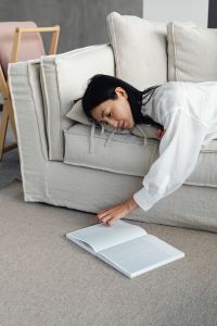 Kaboompics - Woman Reading a Book in a Calm Living Room