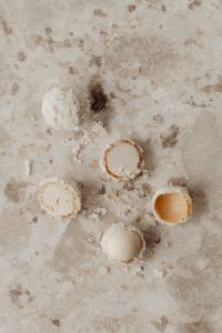 Kaboompics - Overhead Coconut Candy Flat Lay with Cut Truffles and Coconut Flakes on Pale Stone
