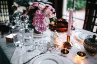 Kaboompics - Christmas Table Decor with Glass Decanters, Pink Beaded Garland and Candlelight