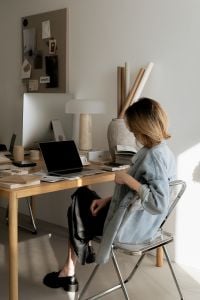 Kaboompics - Interior Designer Working at Laptop among Architectural Material Samples