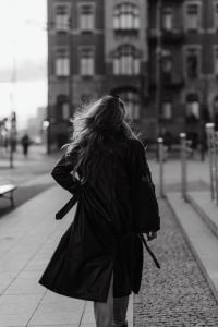 Kaboompics - Black and White Rear View of Woman in Long Coat in City Square