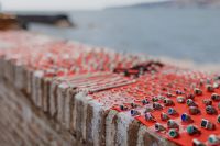 Kaboompics - Colorful Handmade Rings Displayed on Red Cloth by Naples Waterfront