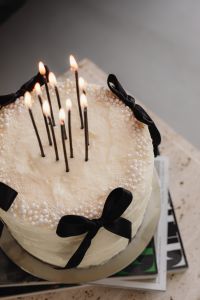 Kaboompics - Close-Up White Cake with Lit Black Candles