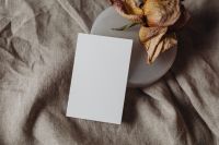 Kaboompics - Portrait Business Card with Dried Flower on Beige Linen Background