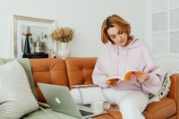 Kaboompics - Woman uses laptop - working from home - reading a book