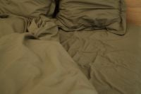 Kaboompics - Unmade Bed with Neutral Linen Bedding in a Cozy Bedroom