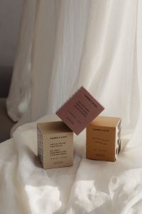 Kaboompics - Pastel Fragrance Boxes on White Draped Fabric