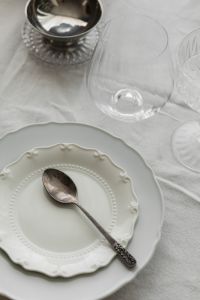 Kaboompics - White Christmas Table Setting with Panettone, Candle and Glassware