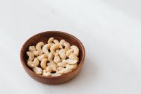 Kaboompics - Cashew Nuts in a Rustic Wooden Bowl for Food Blog and Recipe Content