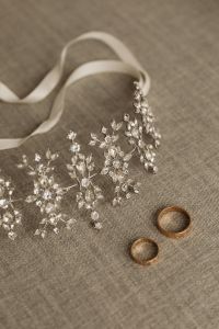 Kaboompics - Gold Bridal Chain and Flower Garland on White Dress Detail