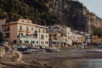 Kaboompics - Marina di Puolo Seafront Buildings at the Foot of a Limestone Cliff