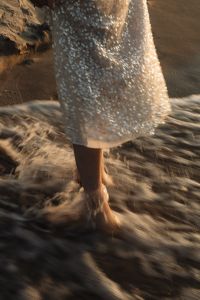 Kaboompics - Motion Blur Barefoot Woman in Sequin Dress Walking Through Waves