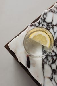 Kaboompics - Overhead Citrus Water Glass on Veined Marble