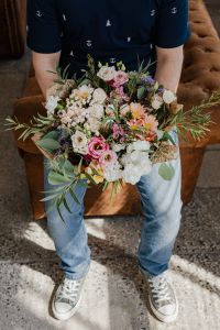 Kaboompics - Man in Navy Anchor-Print Shirt Holding a Pastel Mixed Flower Bouquet