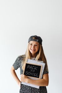 Kaboompics - Teenage Girl Holding Back to School Chalkboard