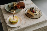 Kaboompics - Dessert Plates and Rosé Wine on a Travertine Table