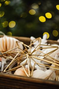 Kaboompics - Gold Star and White Ornaments in a Box