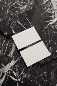 Kaboompics - Two Blank Business Cards Angled in a Vertical Black Marble Mockup