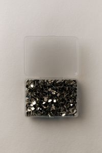 Kaboompics - Metal Thumbtacks in Clear Box