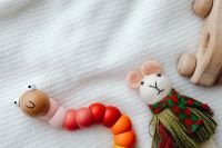 Kaboompics - Wooden Toy Cars, Bead Caterpillar and Fabric Mouse Play Scene