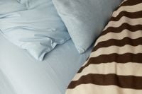 Kaboompics - Soft Blue Bedding With Brown Striped Duvet