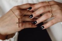 Kaboompics - Gold Cross Necklace Resting on Overlapping Hands