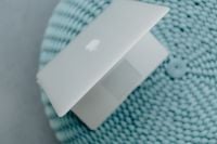 Kaboompics - MacBook Laptop on a blue pouf