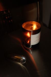 Kaboompics - Burning Amber Candle on Dark Table