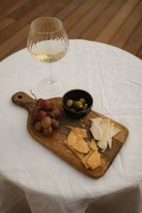 Kaboompics - Red Grapes, Green Olives and Cheese on Wooden Board