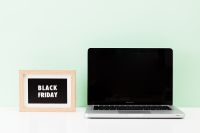 Kaboompics - Black Friday Sign beside Laptop on Mint Green Background