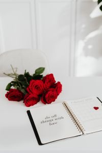 Kaboompics - Open Planner with Do All Things with Love and Red Roses, Romantic Desk Styling
