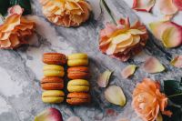 Kaboompics - Two Columns of Colorful French Macarons with Rose Petals on Marble