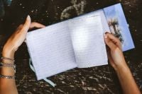 Kaboompics - Woman reading a diary by a table