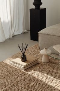 Kaboompics - Minimalist Living Room Decor with Reed Diffuser, Books and Sculptural Vase