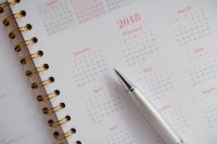 Kaboompics - Soft-Focus Pink Calendar Grid with Silver Pen, Minimal Planning Stationery Background