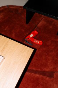 Kaboompics - Retro Red Telephone On Carpet Minimal Interior Detail
