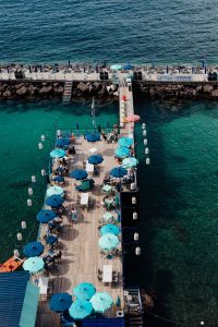 Kaboompics - Overhead View Of Italian Seaside Restaurant Pier With Blue Umbrellas