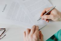 Kaboompics - Doctor Completing Medical Forms at Desk