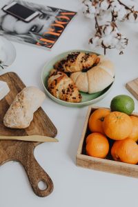 Kaboompics - Oranges, Pastries and Bread on a White Table