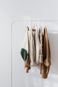Kaboompics - Minimal Hanging Sweaters With White Copy Space