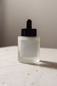 Kaboompics - Minimal Skincare Serum Bottle Mockup with Copy Space on Neutral Travertine