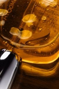 Kaboompics - Amber Liquid Bottle with Bubbles